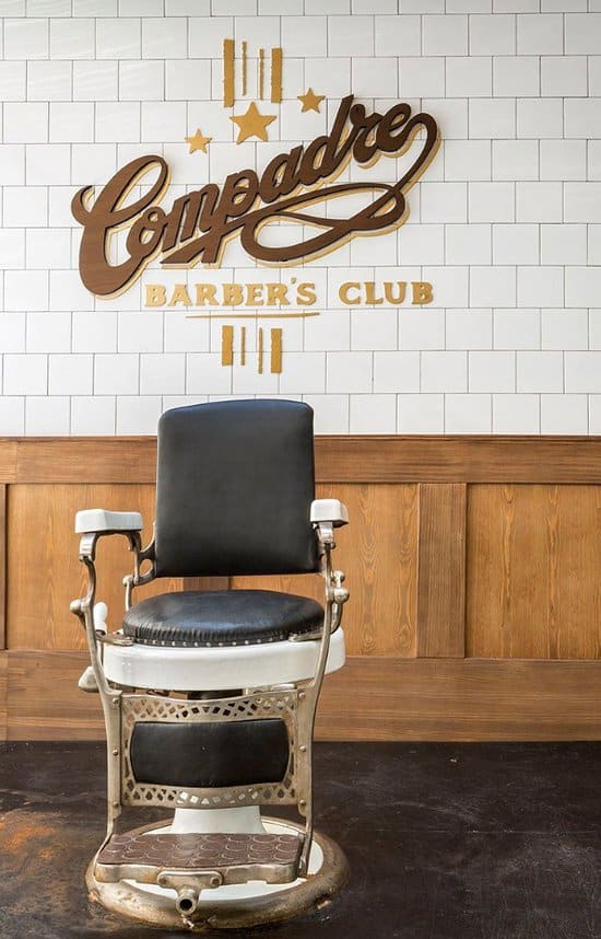 Sit down in the chair to get a haircut or shave at Compadre Barbers Club