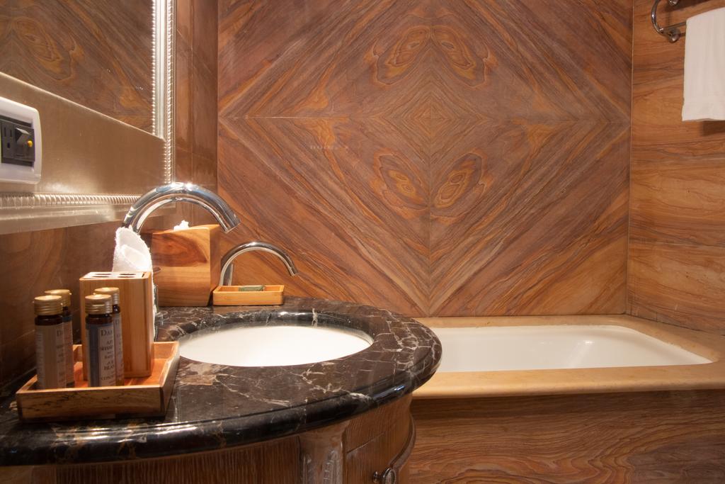 Bathrooms at Villa Palma Boutique Hotel may have bathtubs
