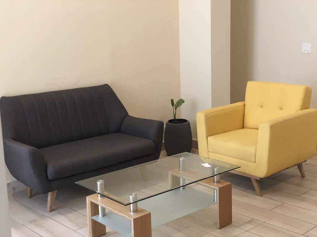 Living room at Casa Franco Panama includes sofa, chair and coffee table