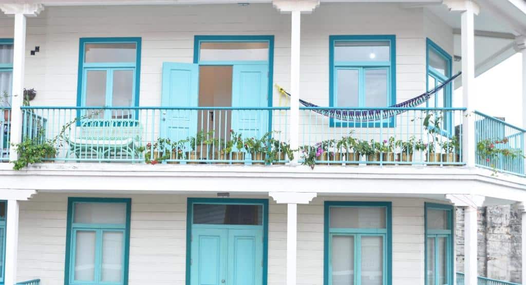 balconies of Flor de Lirio is an Antillean style building that is white with turquoise in Casco Viejo 