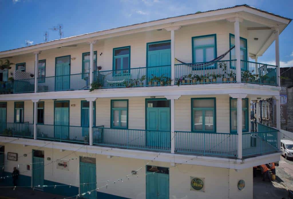 Flor de Lirio is an Antillean style building that is white with turquoise in Casco Viejo 