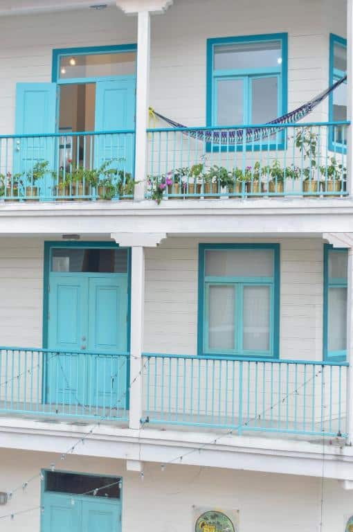 balconies of Flor de Lirio is an Antillean style building that is white with turquoise in Casco Viejo 