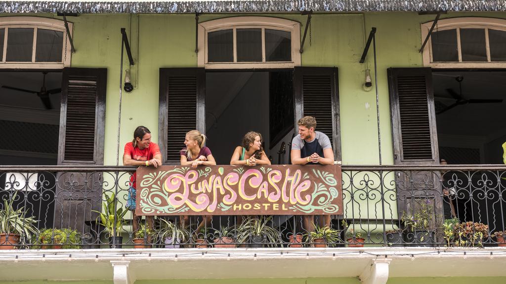 four backpackers on the balcony of Lunas Castle Hostel in casco viejo 