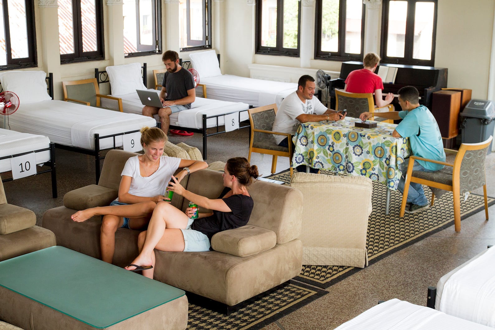 Ballroom dorm is the biggest one at Magnolia Inn with 12 beds, a living room area and a piano