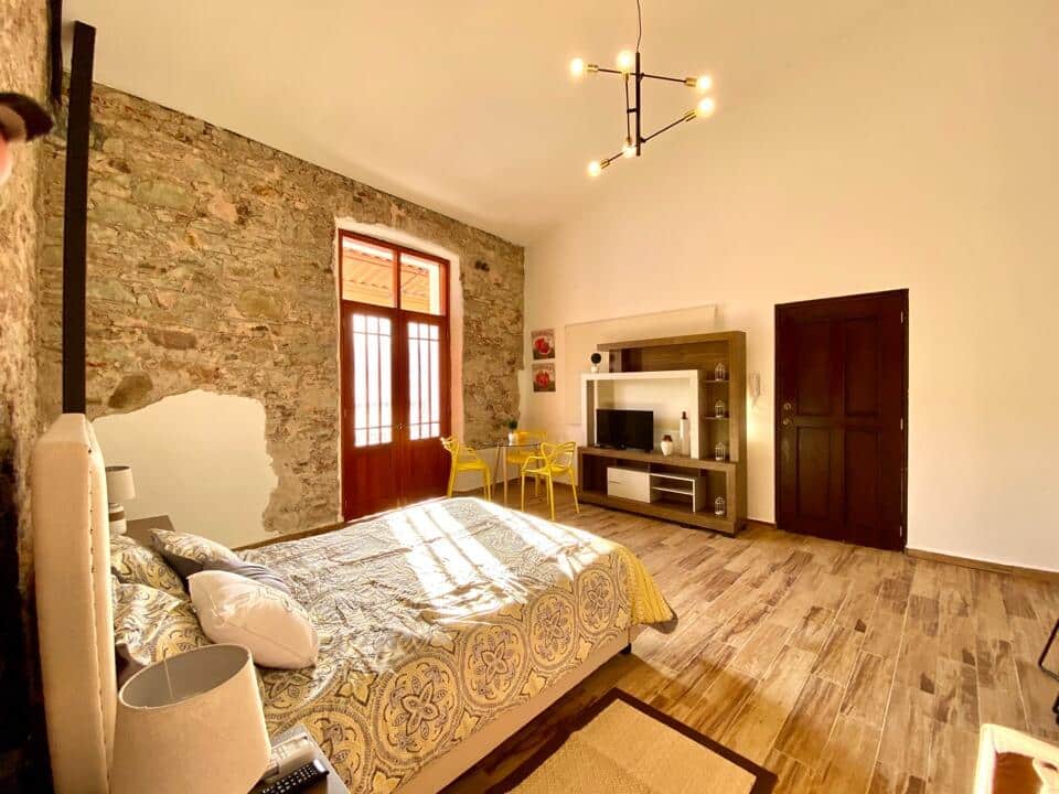Bed and entertainment center with television at Vive Casco Antiguo in Casa Santana