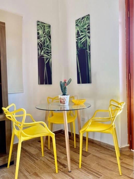 dining table with yellow chairs in Vive Casco Antiguo in Casa Santana