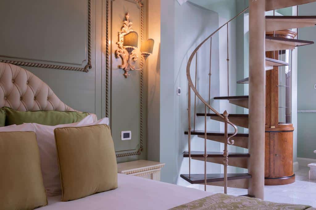 Executive rooms are very spacious with two floors connected by a spiral staircase and balcony in Villa Palma Boutique Hotel
